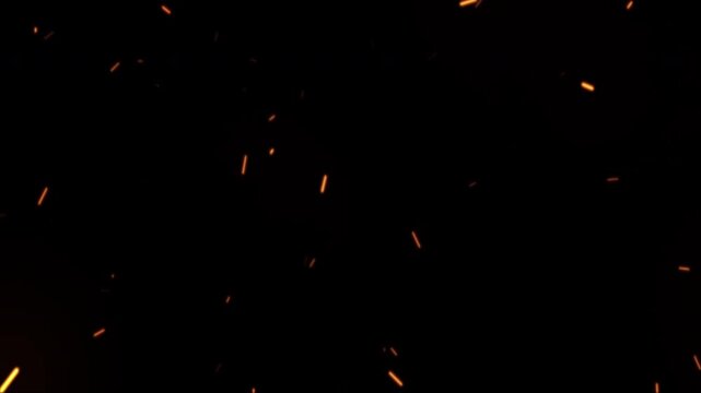 Hot Burning Sparks and Embers Flying Upwards on a Black Background.