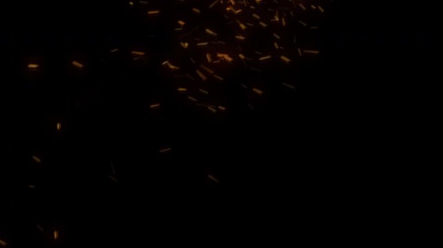 Realistic fire sparks and hot embers floating upwards against a dark black background.