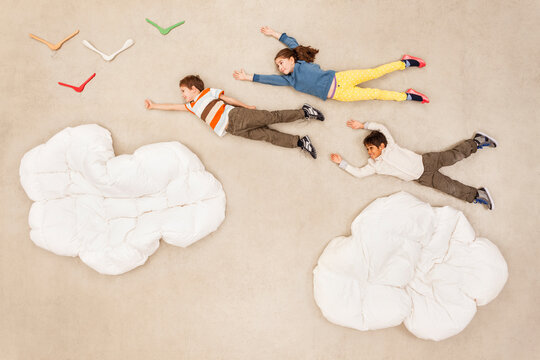 Children flying over clouds