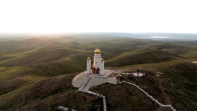 Drone view of the white Adai Ata mausoleum on top of the sacred Mount Otpan Tau. Historical complex and traditional celebration site of the spring Amal holiday. Important cultural landmark  Mangystau