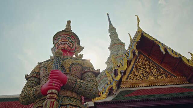 Colorful giant guardian statue at Temple of the Emerald Buddha in Bangkok, ornate Thai architecture landmark in Thailand