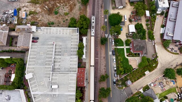 Beautiful aerial view looking straight down on the Metrolink departing San Juan Capistrano train station en route to San Diego.