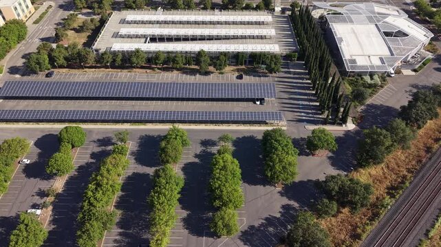 Aerial view of the UC Davis university campus in California, showcasing a large parking lot covered with solar panels and a modern building, highlighting sustainable and renewable energy solutions