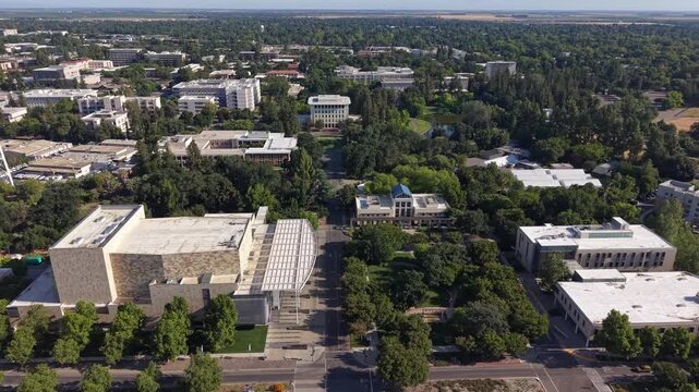 Expansive aerial perspective showing the modern architecture and verdant landscape of the UC Davis campus, a prominent public research university located in Northern California, USA