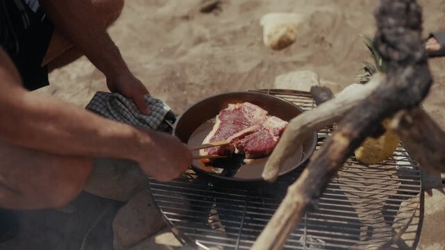 Cooking a T-bone steak in a cast iron pan outdoors