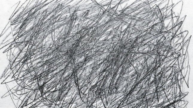 Messy charcoal pencil scribbles and chaotic graphite shading on white paper texture