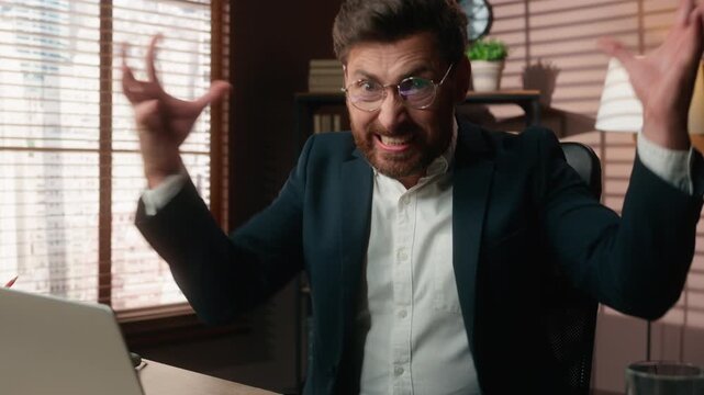 Aggressive Caucasian business man typing laptop screaming with anger yelling shouting angry 40s businessman bearded male yell scream shout with computer online problem failure losing rage in office
