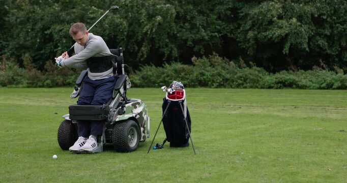 Sports, golf and man in wheelchair on course for game, training and playing competition for recreation. Fitness, golfer and person with a disability with golfing club, ball and hobby for exercise