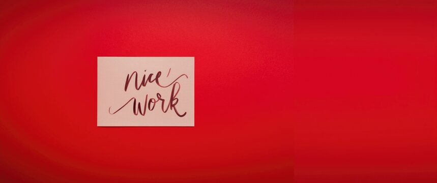 Handwritten NICE WORK note on red background expressing positive praise and compliment
