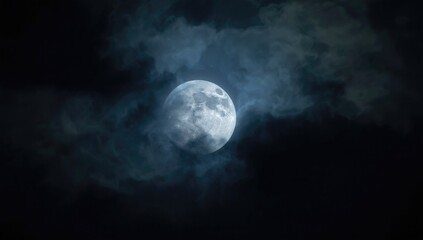 Obraz premium Ethereal full moon shining through clouds in the nighttime atmosphere