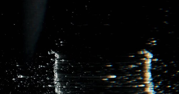 A dynamic water splash occurs when a heavy object hits the water, creating ripples against a dark background. This visual element enhances creative motion graphics and adds a unique touch to projects