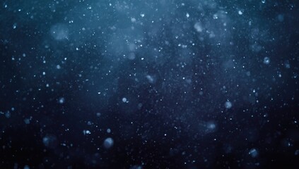 Fototapeta premium Drizzling blue snowflakes sparkling with moisture over a dark wintery backdrop