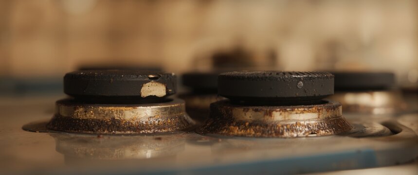 Detailed capture of worn out stove knobs covered in sticky grime and grease