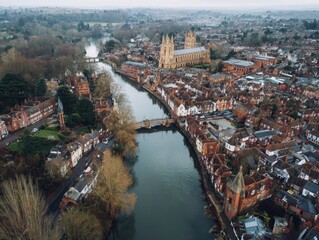 Obraz premium Aerial view of a historic European town with a river, cathedral, and surrounding landscape