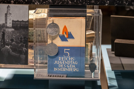 Nuremburg, Germany - 28 Nov 24: Weimar-era youth event booklet and medals on display
