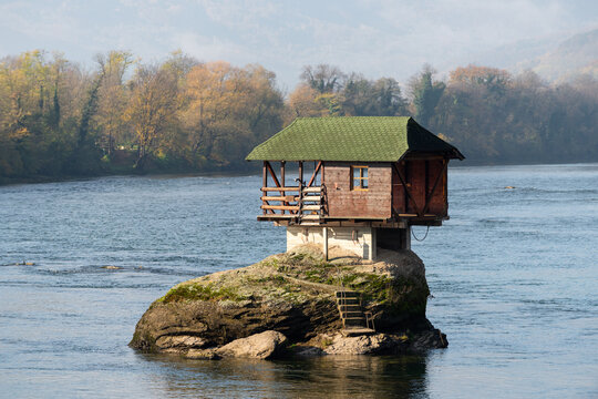 Small wooden house on rock in middle of Drina river near Bajina Basta in Serbia during sunny day