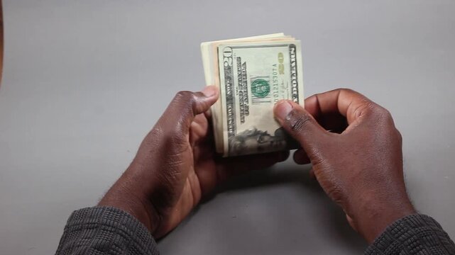 Hands Counting a Stack of United States One Hundred Dollar Bills, Illustrating Global Remittance Flows, Immigrant Earnings, Personal Savings, and Foreign Exchange Liquidity
