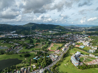 Fototapeta premium Aerial view drone shot of beautiful golf field in Phuket island Thailand