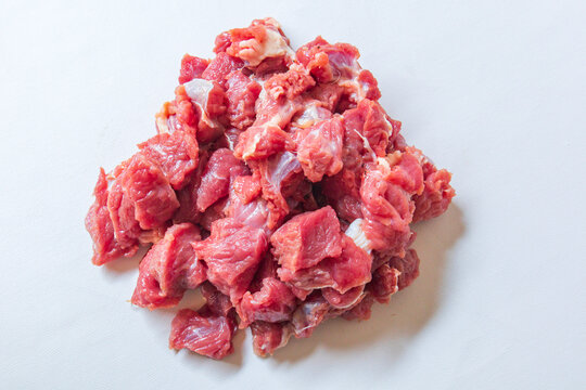 Fresh raw chopped lamb fillet isolated on White Background. Sheep fillet cubes, loin filet for skewers. Diced tenderloin or cubed mutton sirloin meat.