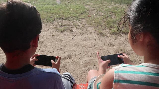 Close-up of an Indian child reacting with frustration while holding and throwing a smartphone after losing a mobile game outdoors. Concept of gaming addiction, screen time, emotional behavior, technol