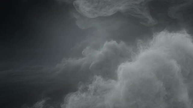 Thick swirling white smoke billowing in darkness creating mysterious patterns and flowing ethereal vapor gas clouds