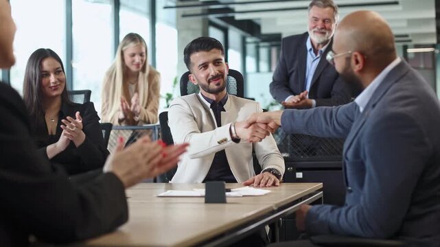 Businesspeople shake hands in a modern office setting