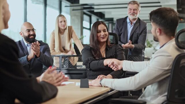Business team discusses strategy around a modern table