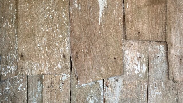 The texture of old wooden planks with faded paint and a natural rustic look, is suitable for use as a design background, vintage elements, as well as traditional and grunge building concepts.