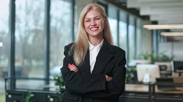 Confident woman smiles warmly, arms crossed
