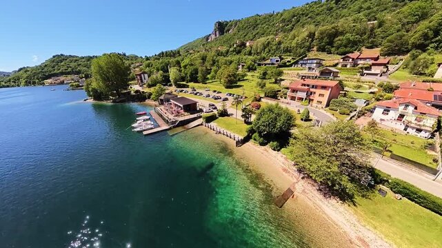 Aerial drone footage showcasing incredibly clear turquoise waters and a beautiful sandy shoreline. The tropical appearance of the water creates a Caribbean-like atmosphere despite the inland lake sett