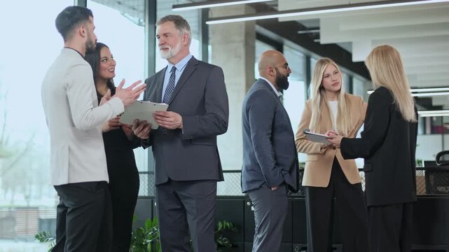 Businesspeople discuss plans in a modern office space