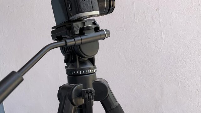 Professional mirrorless camera mounted on a fluid head tripod for smooth video production