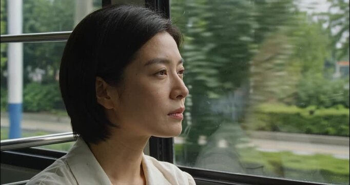 Woman gazing from moving vehicle interior with natural daylight