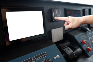 GPS navigation system on boat dashboard. Captain hand pointing at blank monitor screen. Nautical vessel control panel in wheelhouse or ship bridge. Modern boating technology and operation © zephyr_p
