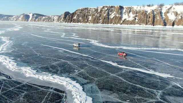 Frozen Lake With Thrilling Vehicle Trip. Automobiles Navigating Across Slick Frozen Ice Landscape