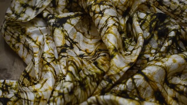 Hand printed crack batik fabric texture with abstract black and golden patterns