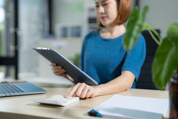 Obraz premium Businesswoman analyzing financial graphs, calculating company expenses, and planning investments, corporate, accounting, and economic strategy.