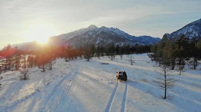 Golden Twilight Over Snowy Terrain. Offroad Vehicle Traverses Icy White Landscape Under Fading Light