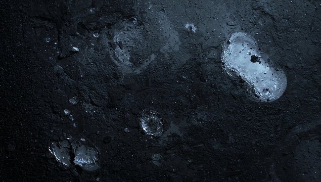 Close-up of Wet Black Soil with Water Droplets and Moisture Texture