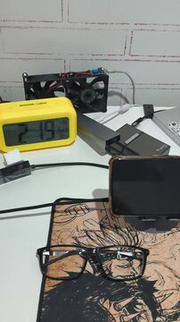 Digital Alarm Clock and Electronic Devices on Work Desk