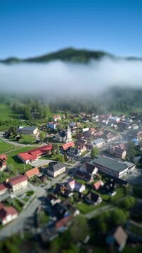 Vertical Aerial Hyperlapse of Mountain Village in Morning Fog with Tilt-Shift Miniature Effect in Spring