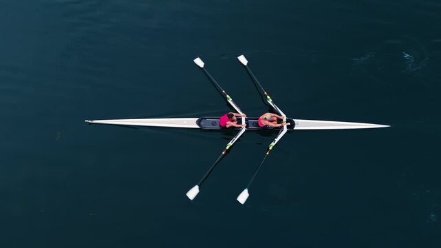 Young athletes practice rowing in single, double, and quadruple boats at a tranquil Halifax bay. Stunning sunrise and calm ocean create a perfect backdrop for their training