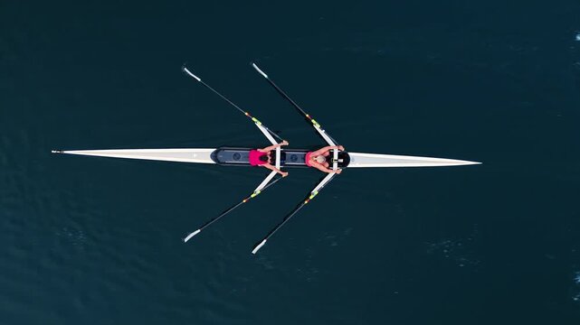 Experience the serene beauty of Halifax, Nova Scotia, as young athletes row in multiple boats during their early morning training session. The sunrise reflects on calm waters