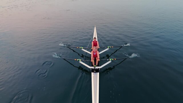 Athletes practice early in the peaceful Halifax Harbor, showcasing their skills in single, double, and quadruple rowing boats as the sun rises over the tranquil ocean