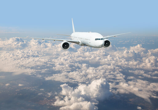 Commerical passenger airplane flying in the sky over storm clouds