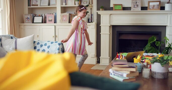 Dance, child and girl with laptop in living room, sassy movement and internet tutorial for weekend fun. Energy, learning and happy kid with music video for choreography practice, home and computer