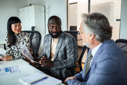 Business team reviewing documents in conference room