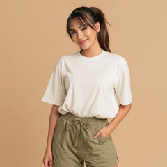 Obraz premium Stylish woman in a plain white t-shirt on a warm beige background, perfect for mockup or fashion branding.