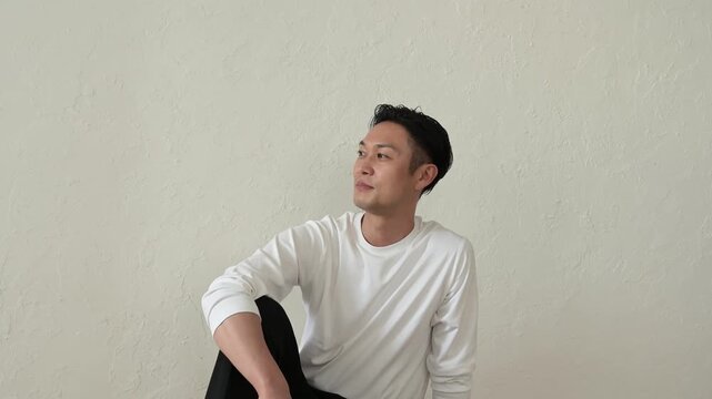 リビングで座ってリラックスする日本人男性
