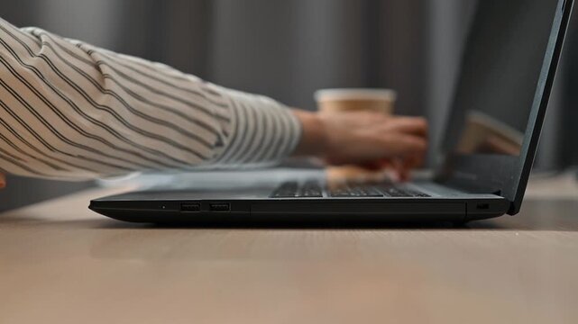 A female character opens a laptop and starts typing